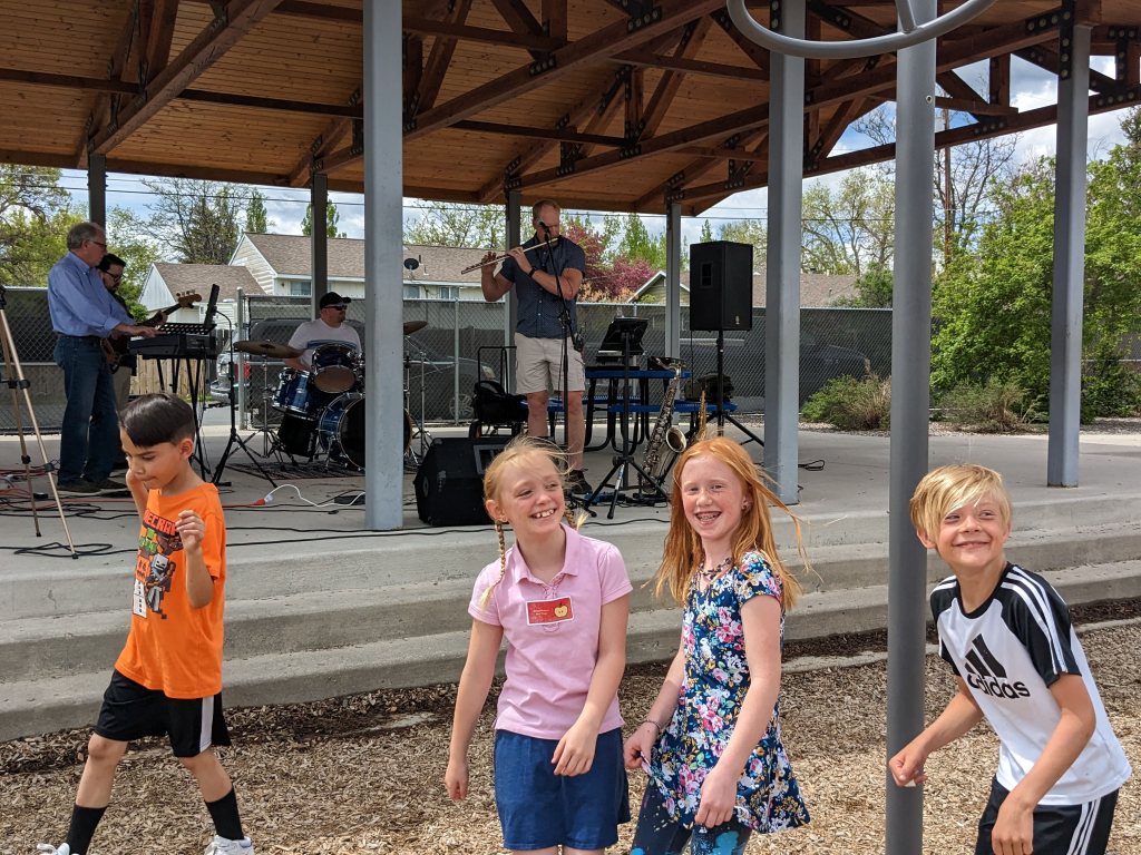 Children dance to music at an outdoor concert
