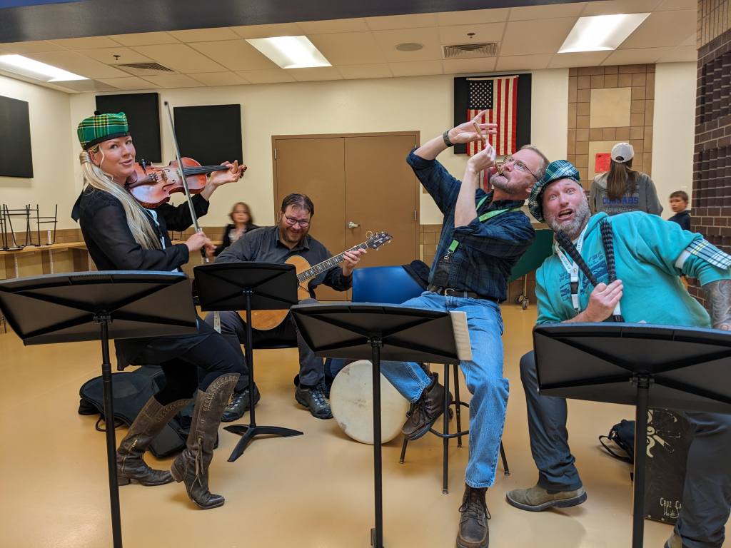 A group of musicians in costume poses for a funny photo